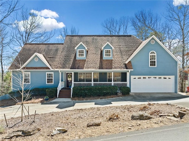 view of front of house with a porch, concrete driveway, and an attached garage