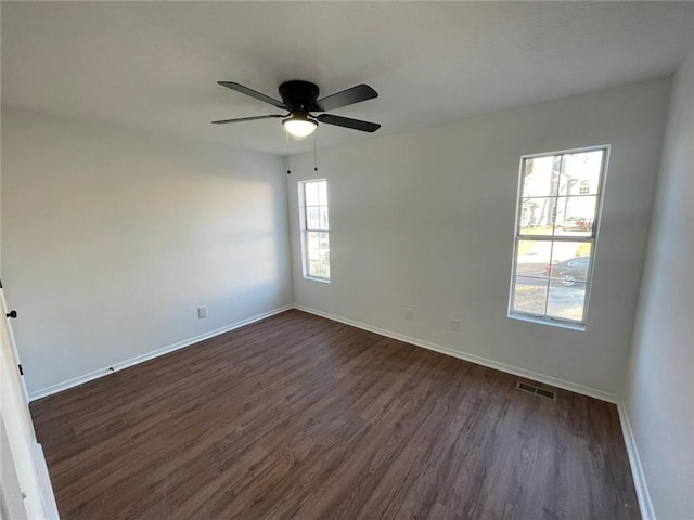 spare room featuring dark hardwood / wood-style floors and ceiling fan