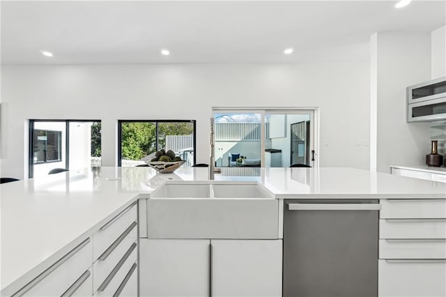 kitchen featuring dishwasher, light countertops, recessed lighting, modern cabinets, and white cabinets