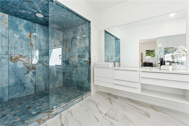 bathroom with a marble finish shower, vanity, and marble finish flooring