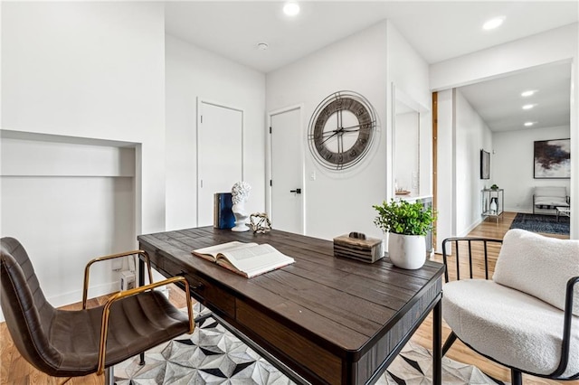 office space featuring light wood-type flooring, recessed lighting, and baseboards