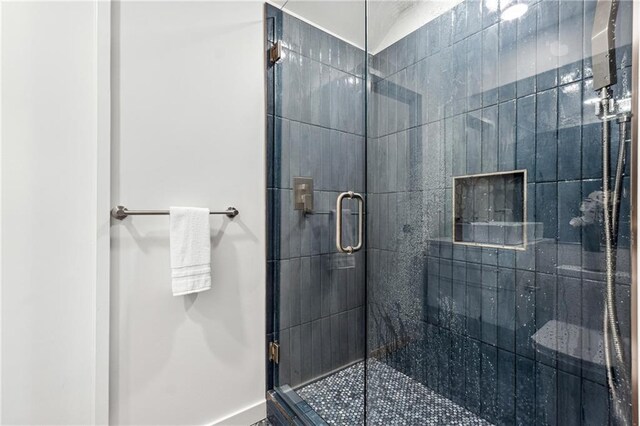 bathroom with vanity, a tile shower, and toilet