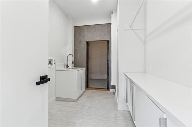 laundry room with cabinet space, baseboards, and hookup for a washing machine