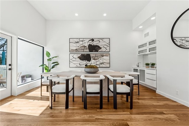 dining area with recessed lighting and light wood-style floors