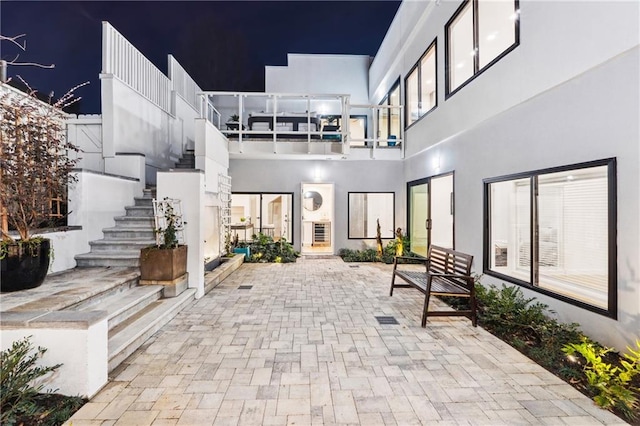 view of home's community with stairs and a patio