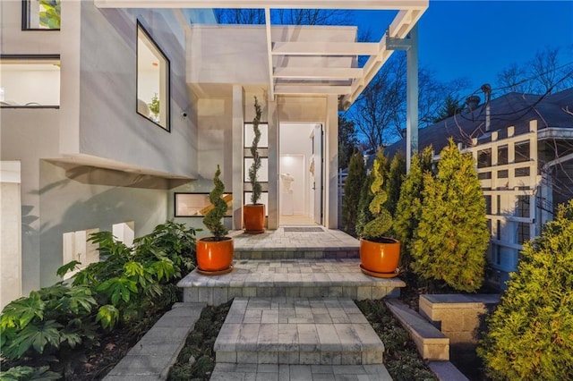 entrance to property featuring stucco siding