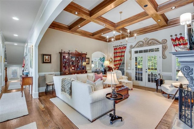 living room featuring french doors, coffered ceiling, beamed ceiling, hardwood / wood-style flooring, and ornamental molding