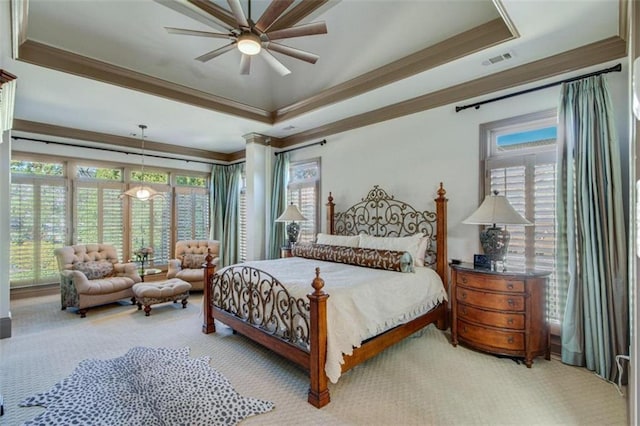 bedroom with a raised ceiling, ceiling fan, carpet, and ornamental molding