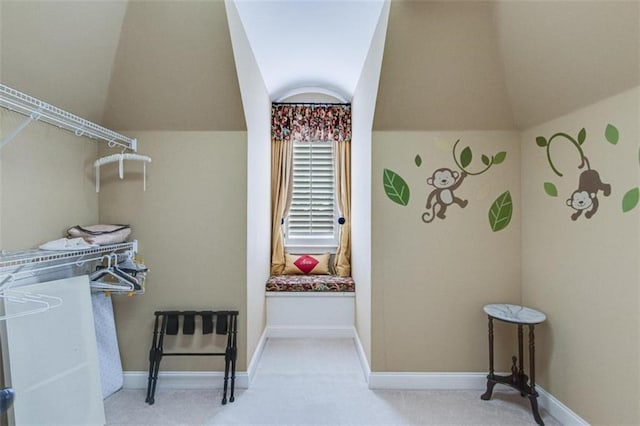 spacious closet with carpet and vaulted ceiling