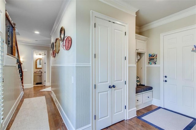 hall with dark hardwood / wood-style floors and ornamental molding