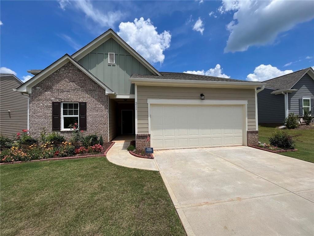 view of front facade with a garage and a front lawn