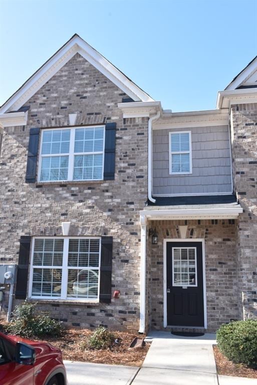 view of property featuring brick siding