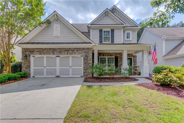 7653 Legacy Rd, Flowery Branch, GA 30542 - craftsman inspired home with driveway, stone siding, a garage, and a front yard