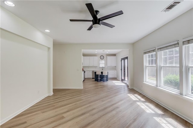 7653 Legacy Rd, Flowery Branch, GA 30542 - unfurnished living room featuring recessed lighting, baseboards, ceiling fan, light wood finished floors, and a sink