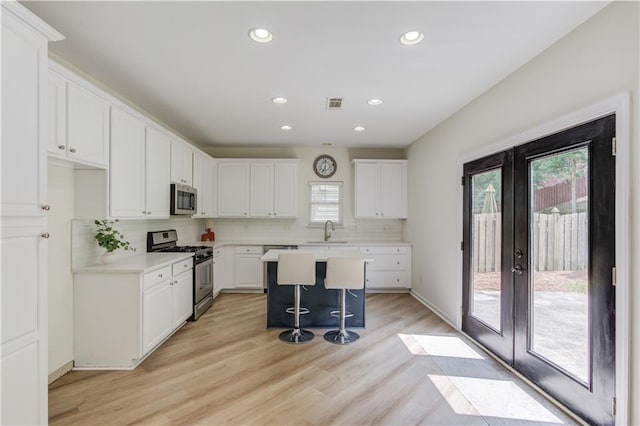 7653 Legacy Rd, Flowery Branch, GA 30542 - kitchen with stainless steel appliances, a sink, french doors, healthy amount of natural light, and recessed lighting