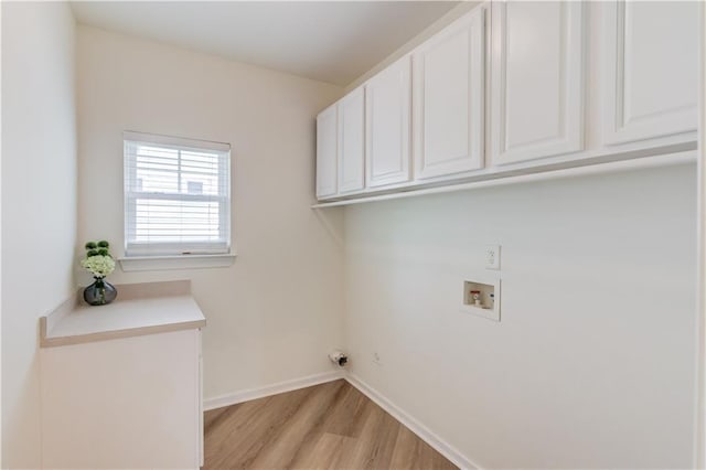 7653 Legacy Rd, Flowery Branch, GA 30542 - laundry room featuring cabinet space, light wood finished floors, washer hookup, and baseboards