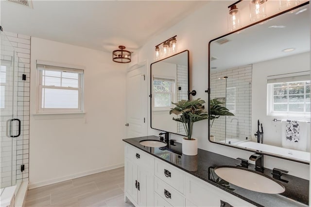 7653 Legacy Rd, Flowery Branch, GA 30542 - bathroom featuring a shower stall, double vanity, and baseboards