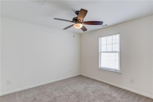 7653 Legacy Rd, Flowery Branch, GA 30542 - spare room with healthy amount of natural light, baseboards, a ceiling fan, and light colored carpet
