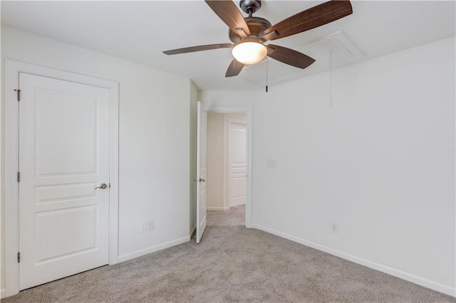 7653 Legacy Rd, Flowery Branch, GA 30542 - unfurnished bedroom featuring attic access, light colored carpet, baseboards, and ceiling fan