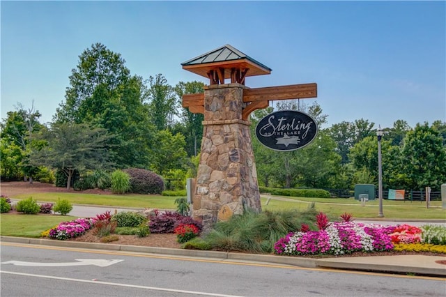 7653 Legacy Rd, Flowery Branch, GA 30542 - community sign with a yard and view of scattered trees