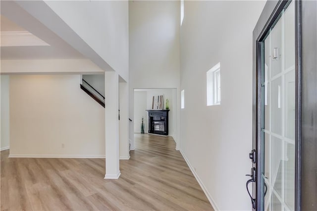 7653 Legacy Rd, Flowery Branch, GA 30542 - entryway featuring light wood-style floors, baseboards, and a glass covered fireplace