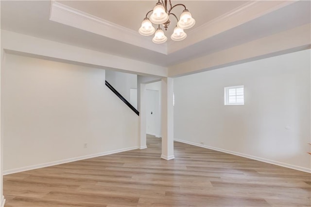 7653 Legacy Rd, Flowery Branch, GA 30542 - below grade area featuring crown molding, a chandelier, light wood-type flooring, and baseboards