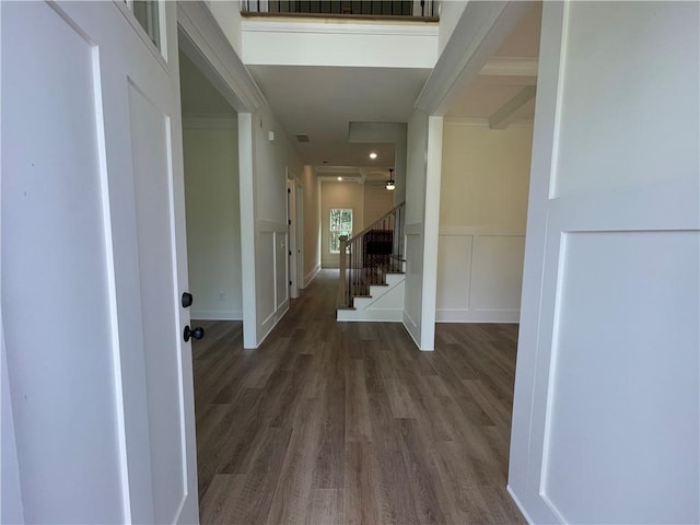 entryway with dark hardwood / wood-style floors and beam ceiling