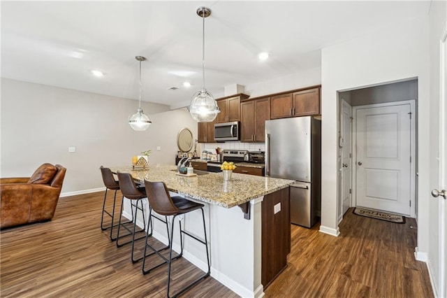 kitchen featuring dark wood-style floors, visible vents, dishwasher, and a sink