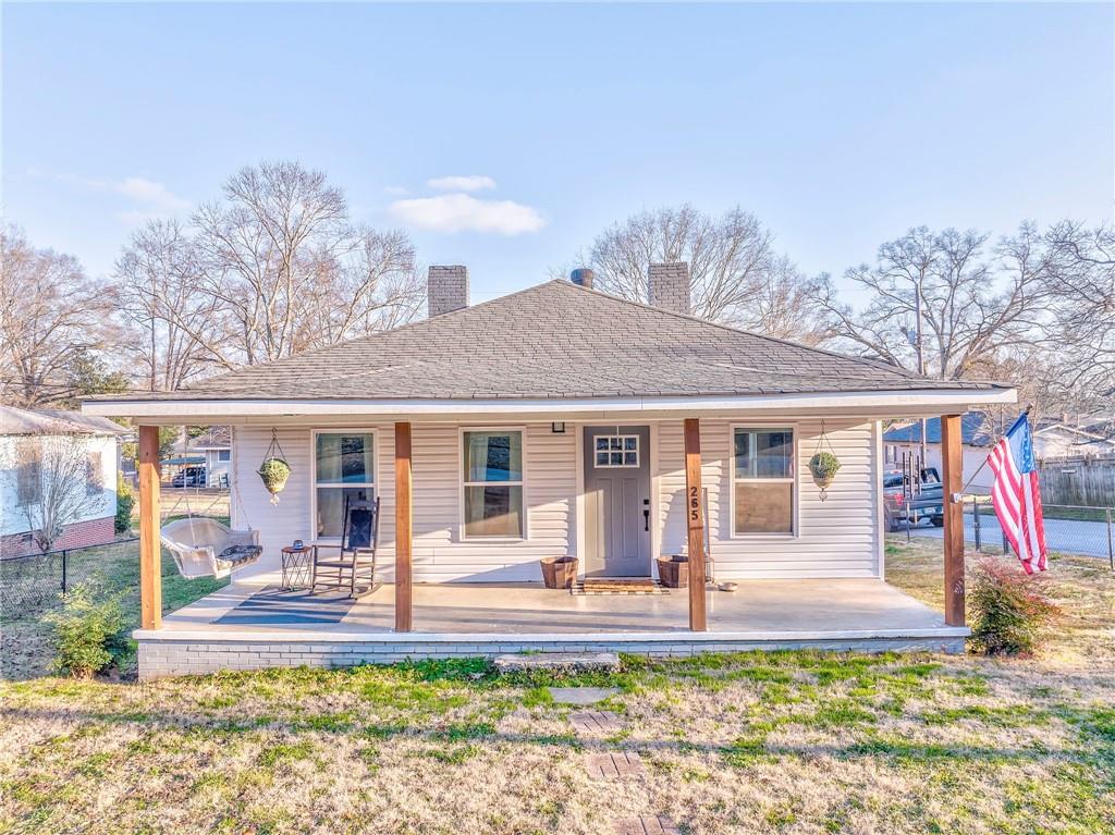 rear view of property with covered porch