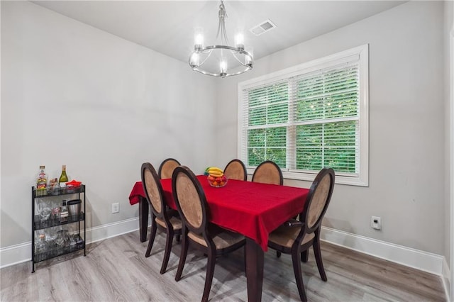 dining room featuring hardwood / wood-style floors and a notable chandelier