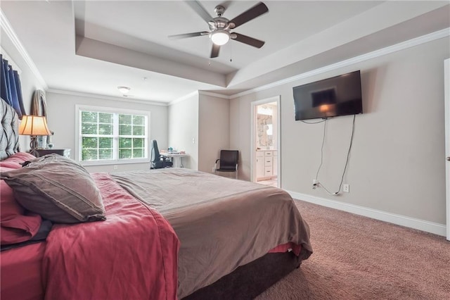 bedroom with a tray ceiling, ensuite bath, ceiling fan, and carpet