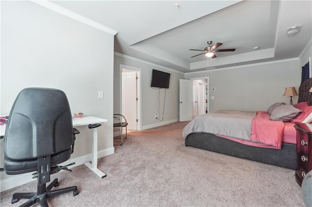 carpeted bedroom with a raised ceiling, ceiling fan, and ornamental molding