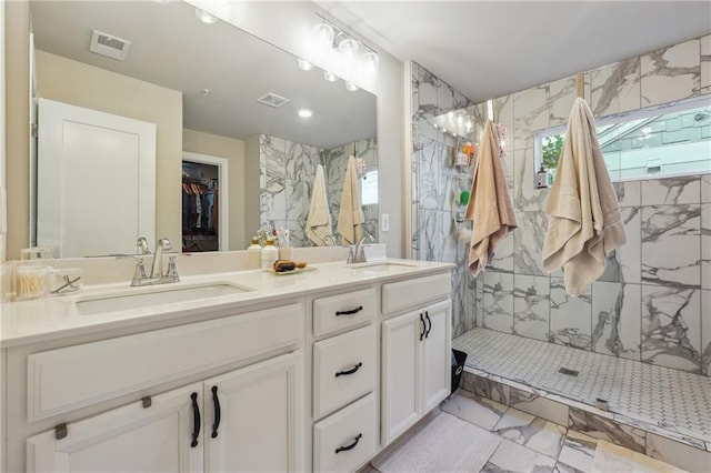 bathroom featuring vanity and tiled shower