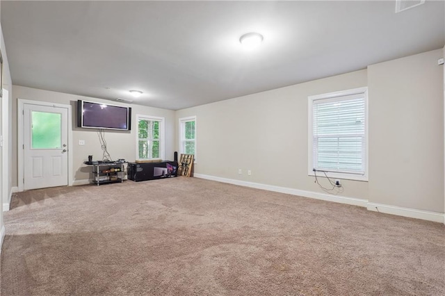 unfurnished living room featuring carpet