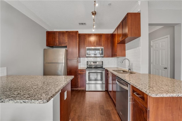 kitchen featuring dark hardwood / wood-style floors, tasteful backsplash, sink, stainless steel appliances, and light stone countertops