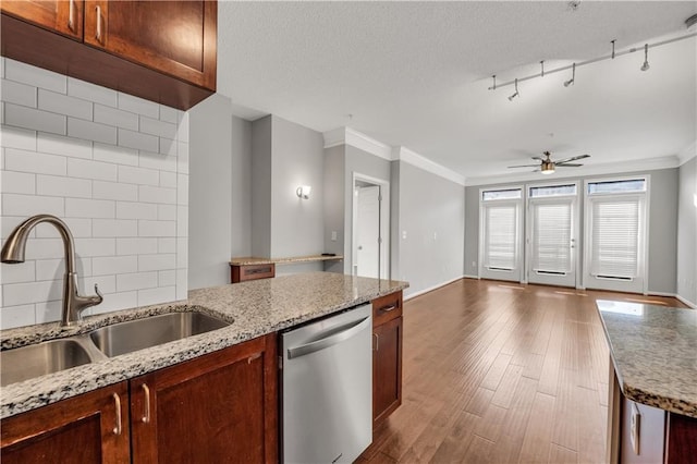 kitchen featuring sink, dishwasher, ornamental molding, dark hardwood / wood-style flooring, and decorative backsplash