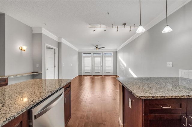 kitchen with decorative light fixtures, light stone countertops, dark hardwood / wood-style floors, and dishwasher