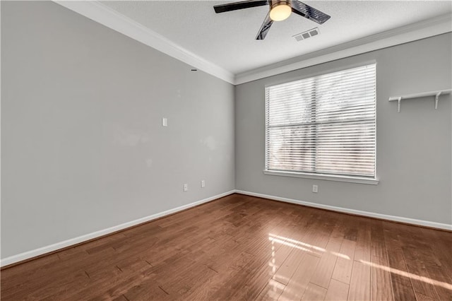 empty room with crown molding, ceiling fan, hardwood / wood-style floors, and a textured ceiling