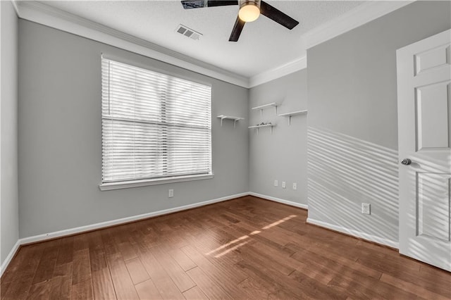 empty room featuring crown molding, wood-type flooring, and ceiling fan