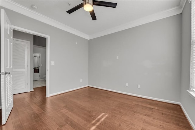 spare room featuring hardwood / wood-style flooring, ornamental molding, and ceiling fan