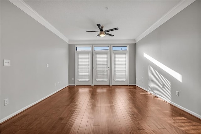 spare room with crown molding, hardwood / wood-style flooring, and ceiling fan