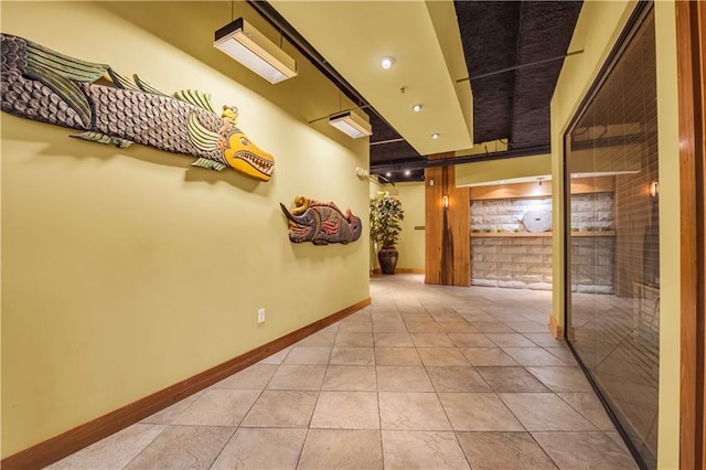 hall with light tile patterned floors