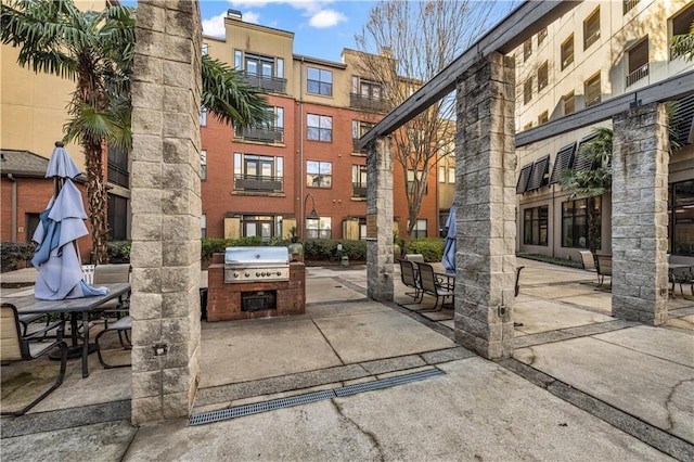 surrounding community featuring a patio area and exterior kitchen