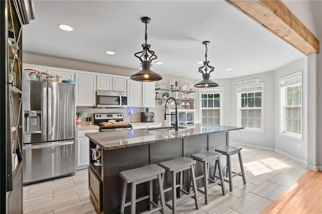 244 Bryn Brooke Dr, Dawsonville, GA 30534 - kitchen with appliances with stainless steel finishes, a sink, light wood-type flooring, white cabinetry, and a breakfast bar