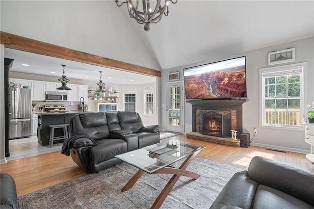 244 Bryn Brooke Dr, Dawsonville, GA 30534 - living room with a chandelier, recessed lighting, a stone fireplace, light wood finished floors, and high vaulted ceiling