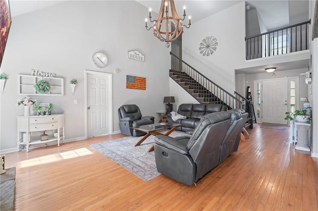 244 Bryn Brooke Dr, Dawsonville, GA 30534 - living room featuring stairway, high vaulted ceiling, hardwood / wood-style floors, a chandelier, and baseboards