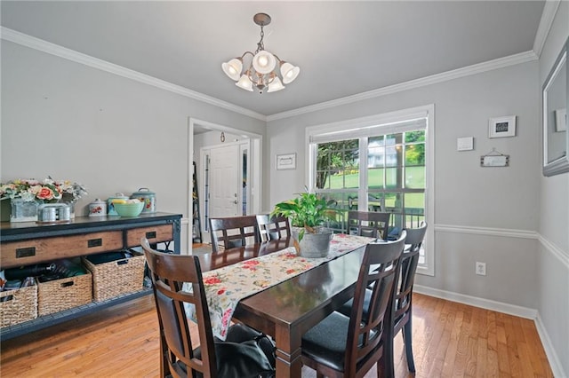 244 Bryn Brooke Dr, Dawsonville, GA 30534 - dining area with a chandelier, baseboards, light wood finished floors, and crown molding