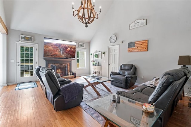 244 Bryn Brooke Dr, Dawsonville, GA 30534 - living room with high vaulted ceiling, a chandelier, hardwood / wood-style floors, baseboards, and a stone fireplace