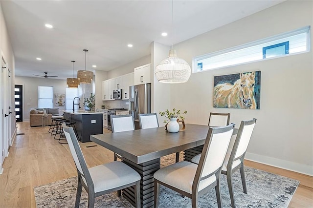 dining space featuring recessed lighting, baseboards, plenty of natural light, and light wood finished floors