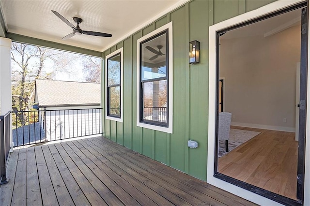 wooden terrace with a ceiling fan